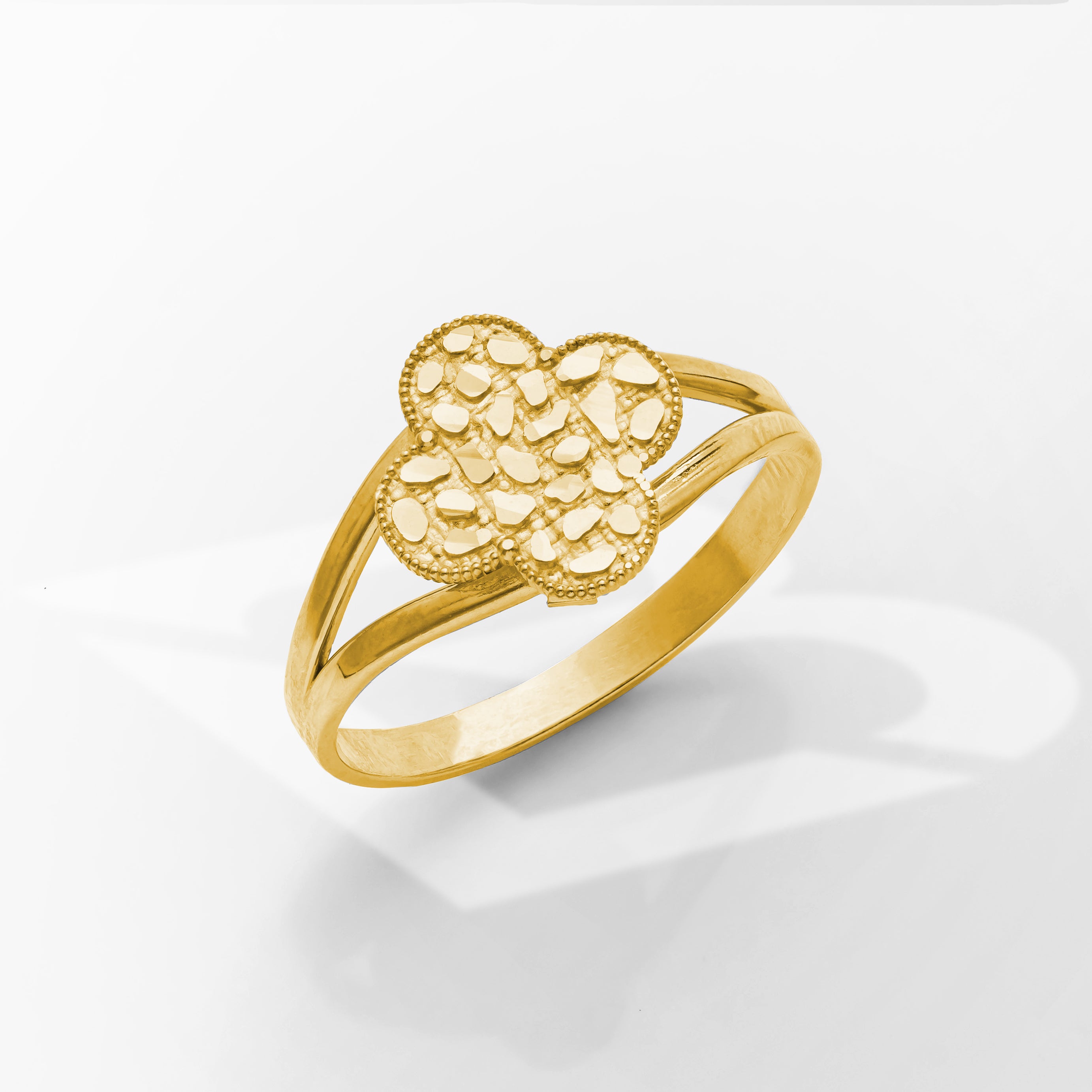 Gold ring with a textured design on a white background
