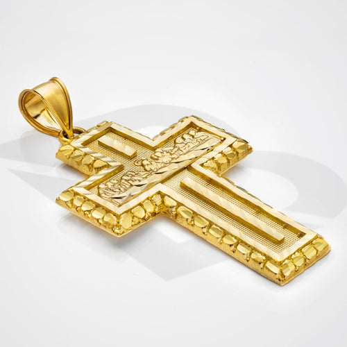 Gold cross pendant on a white background